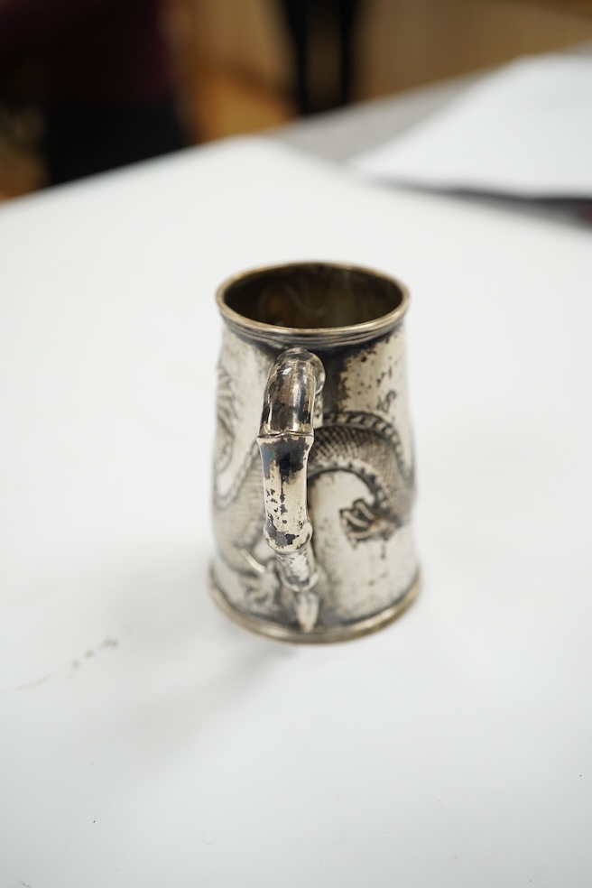 A small Chinese Export white metal mug, embossed with a dragon, 68mm, 66 grams. Condition - fair